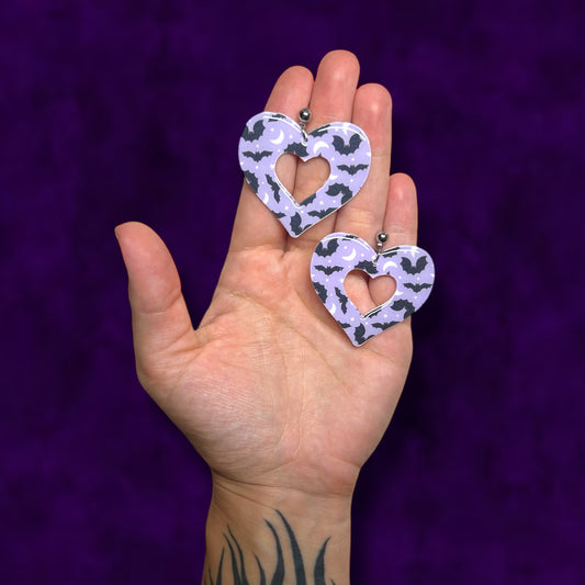 Bat moon stars mod heart resin statement earrings being held