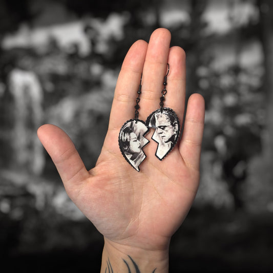 Bride of Frankenstein broken heart beaded resin statement earrings being held