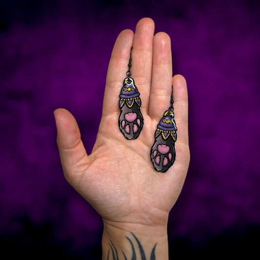 Witchy hand-painted gold cat paw black cat familiar resin statement earrings being held