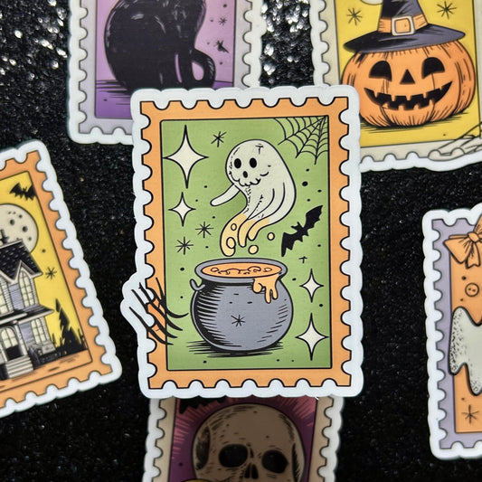 Sticker of a ghost in a cauldron on a green background surrounded by similar Halloween-themed stamp stickers.