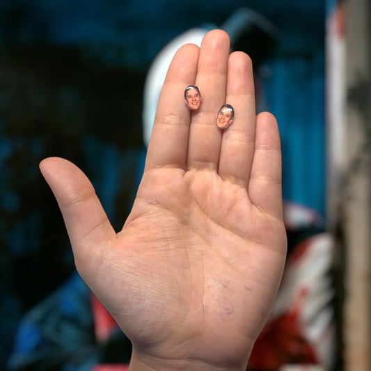 David Howard Thornton face resin stud earrings being held