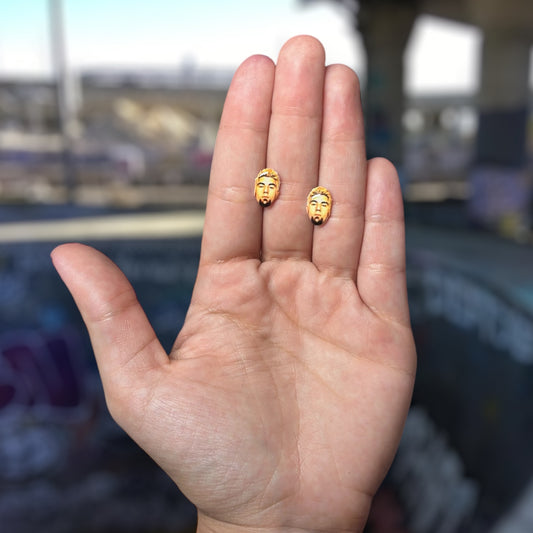 Deftones Chino Moreno resin stud earrings being held