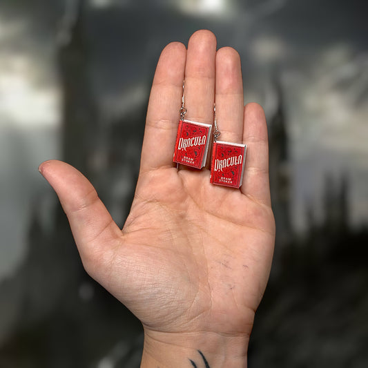 Dracula Bram Stoker miniature book dangle earrings being held