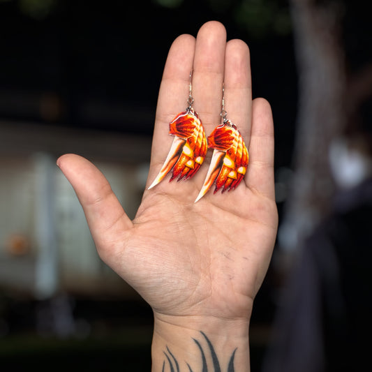Halloween-inspired Michael Myers knife resin statement earrings being held