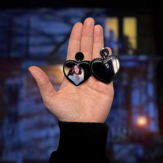 Halloween-inspired Michael Myers Laurie Strode closet scene heart-shaped resin statement earrings being held