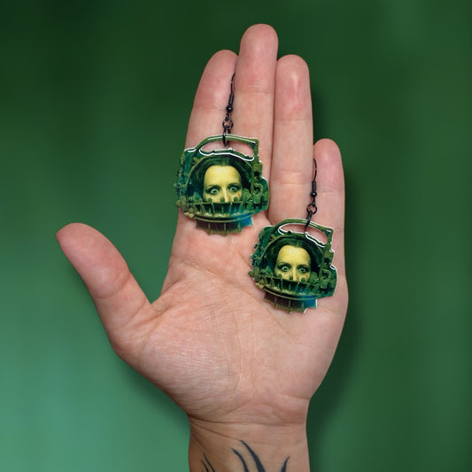 SAW Amanda in reverse bear trap resin statement earrings being held