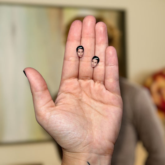 Jackson Rathbone face resin stud earrings being held