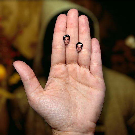 Jake Gyllenhaal face resin stud earrings being held