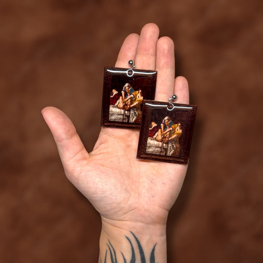 Judith Slaying Holofernes Artemisia Gentileschi framed art resin statement earrings being held