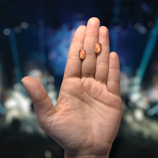 Meshuggah Jens Kidman resin stud earrings being held