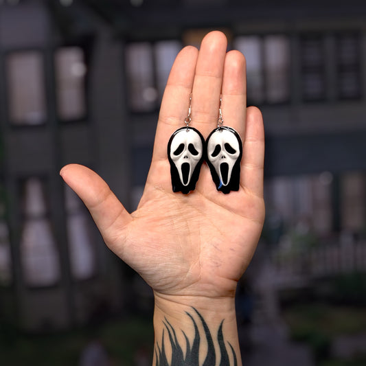Scream-inspired Ghotsface mask resin statement earrings being held