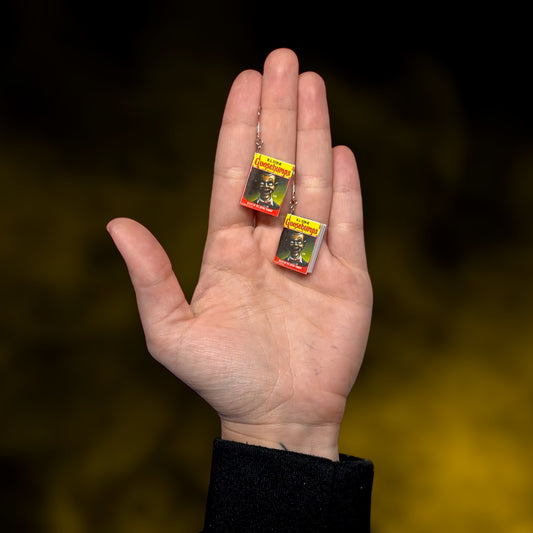 Goosebumps Night of the Living Dummy miniature book dangle earrings being held