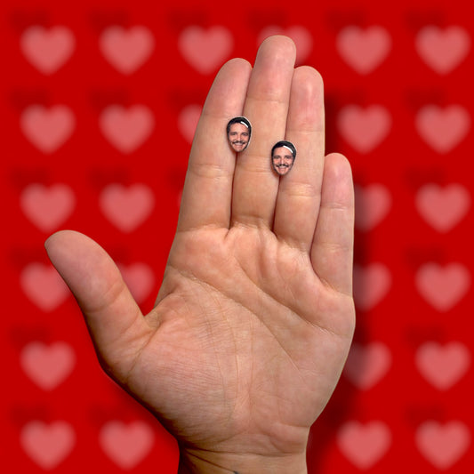 Pedro Pascal face resin stud earrings being held