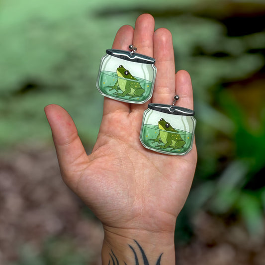 Frog in a jar oddities curiosities pet frog swamp witchy resin statement earrings being held