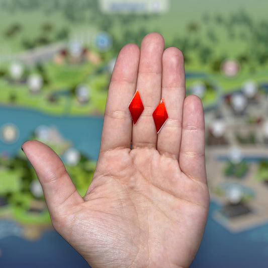 The Sims-inspired The Sims 4 TS4 red plumbob resin stud earrings being held