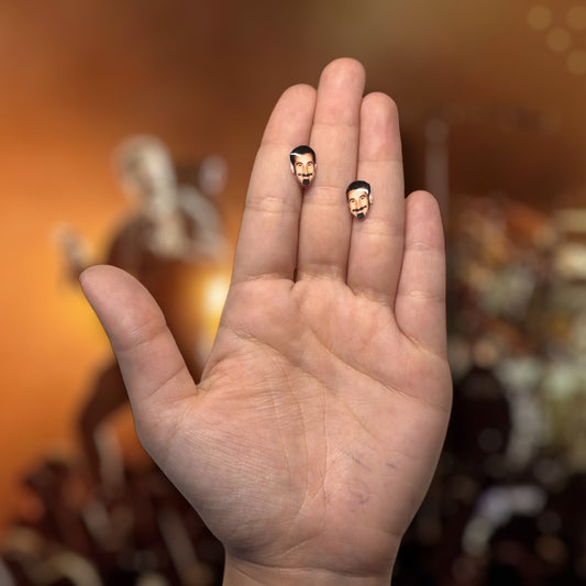 System of a Down Serj Tankian face resin stud earrings being held