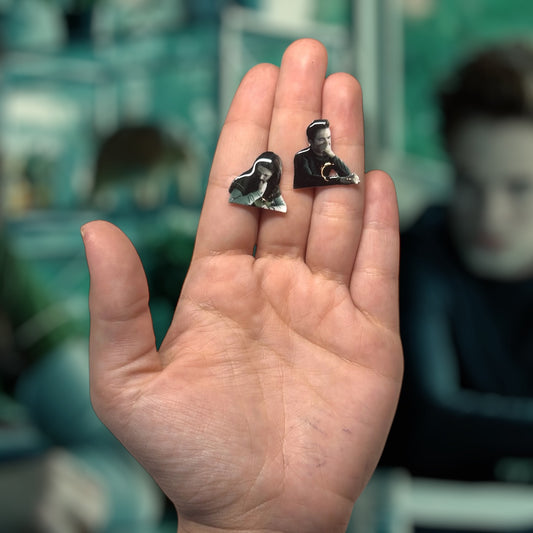 Twilight-inspired Edward Cullen and Bella Swan stinky bio class resin stud earrings being held