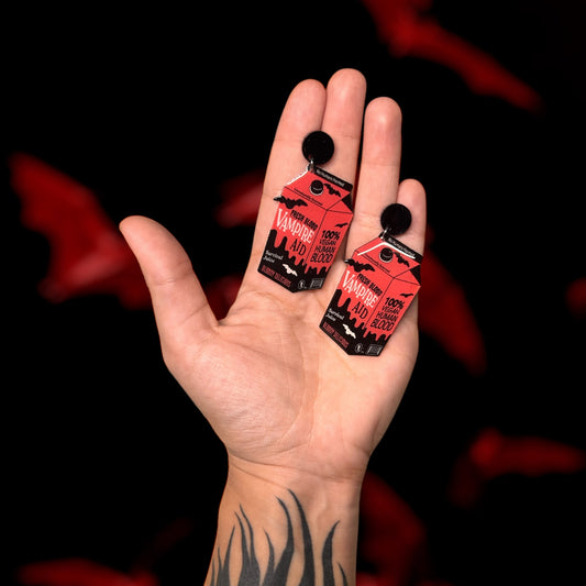 Vampire Aid blood drink resin statement earrings being held