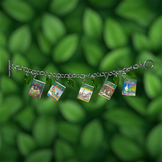 Magic Treehouse miniature book and green leaf charm bracelet on a green leafy background