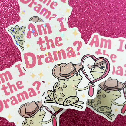 Sticker with cartoon frog wearing a cowboy hat and holding a mirror and text 'Am I the Drama?' on a pink glittery background