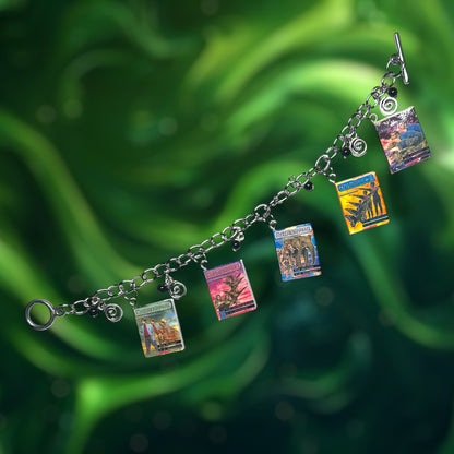 Bracelet with Animorphs books, black glass beads, and swirl charms on a green background.