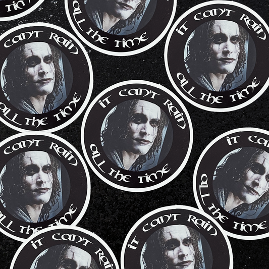 The Crow Eric Draven sticker and text 'It can't rain all the time' on a black background.