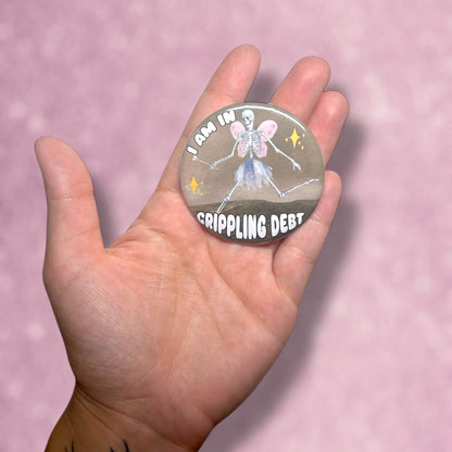 Crippling debt fairy skeleton wearing tutu button being held