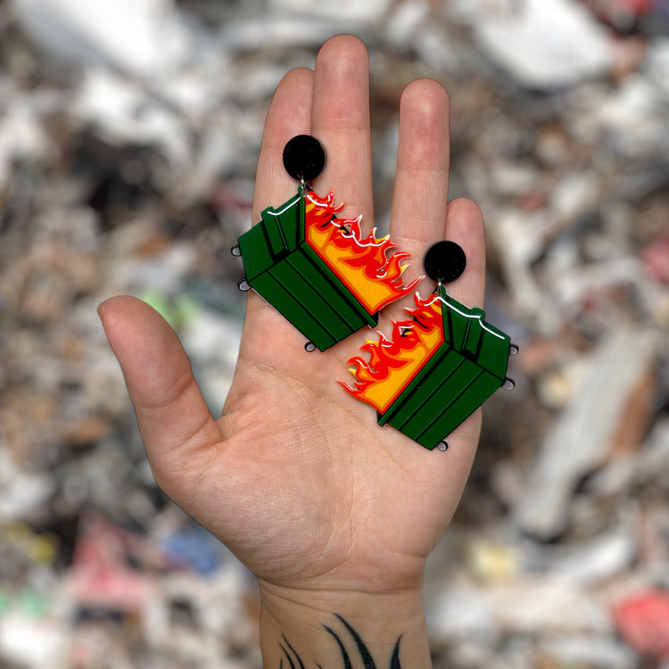 Dumpster fire resin statement earrings being held