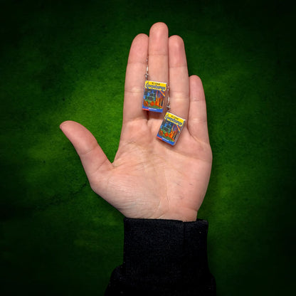 Goosebumps Monster Blood miniature book dangle earrings being held