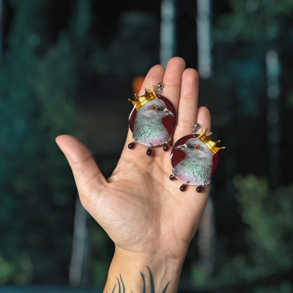 Hereditary-inspired Hail Paimon crown pigeon glass blood drops resin statement earrings being held