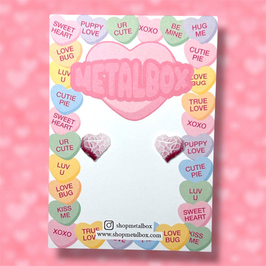 Little Debbie Valentine's Day heart snack cake stud earrings on a pink background