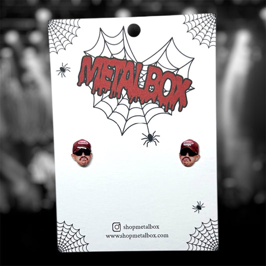 Kublai Khan Matt Honeycutt resin stud earrings on a blurry black and white background