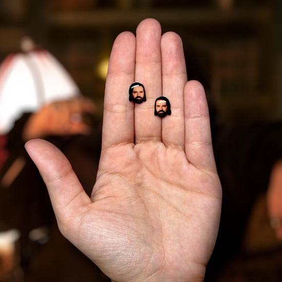 Matt Berry face resin stud earrings being held