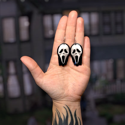 Scream-inspired Ghotsface mask resin statement earrings being held