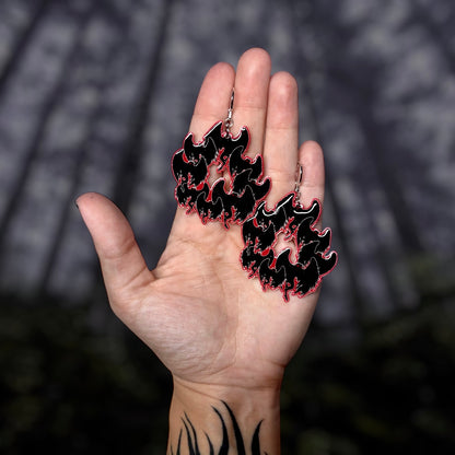 Mothman cryptid mod hoop resin statement earrings being held
