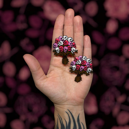 Multicolored skull bouquet multiple colors Valentine's Day Valloween spooky flowers resin statement earrings being held