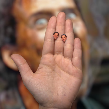 Nicolas Cage face resin stud earrings being held