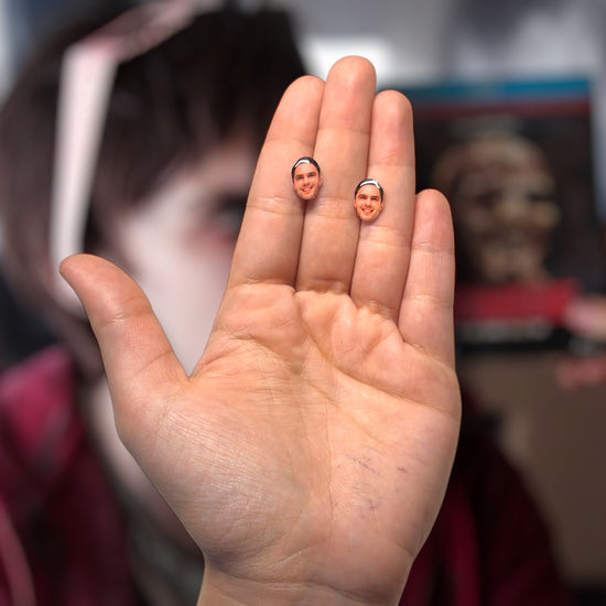 Nicholas Hoult face resin stud earrings being held