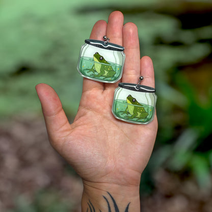 Frog in a jar oddities curiosities pet frog swamp witchy resin statement earrings being held