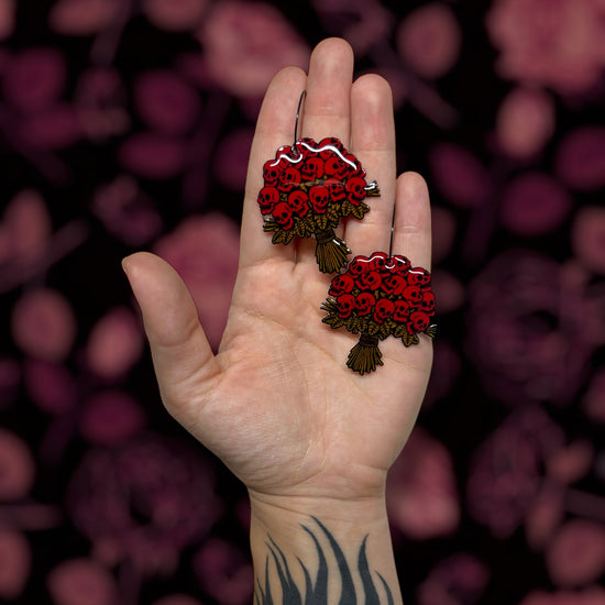 Red skull bouquet multiple colors goth Valentine's Day Valloween spooky flowers resin statement earrings being held