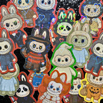 Stickers of Labubus dressed as horror movie icons on a black background