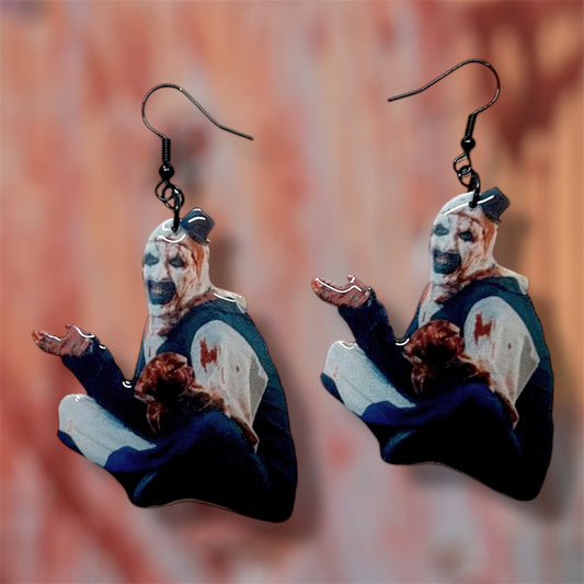 Terrifier Art the Clown bloody outfit scary clown bedroom scene resin earrings on a blurred background