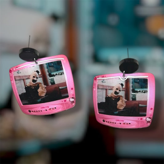 Terrifier Art the Clown diner scene Hello Kitty TV resin dangle earrings on a blurry background