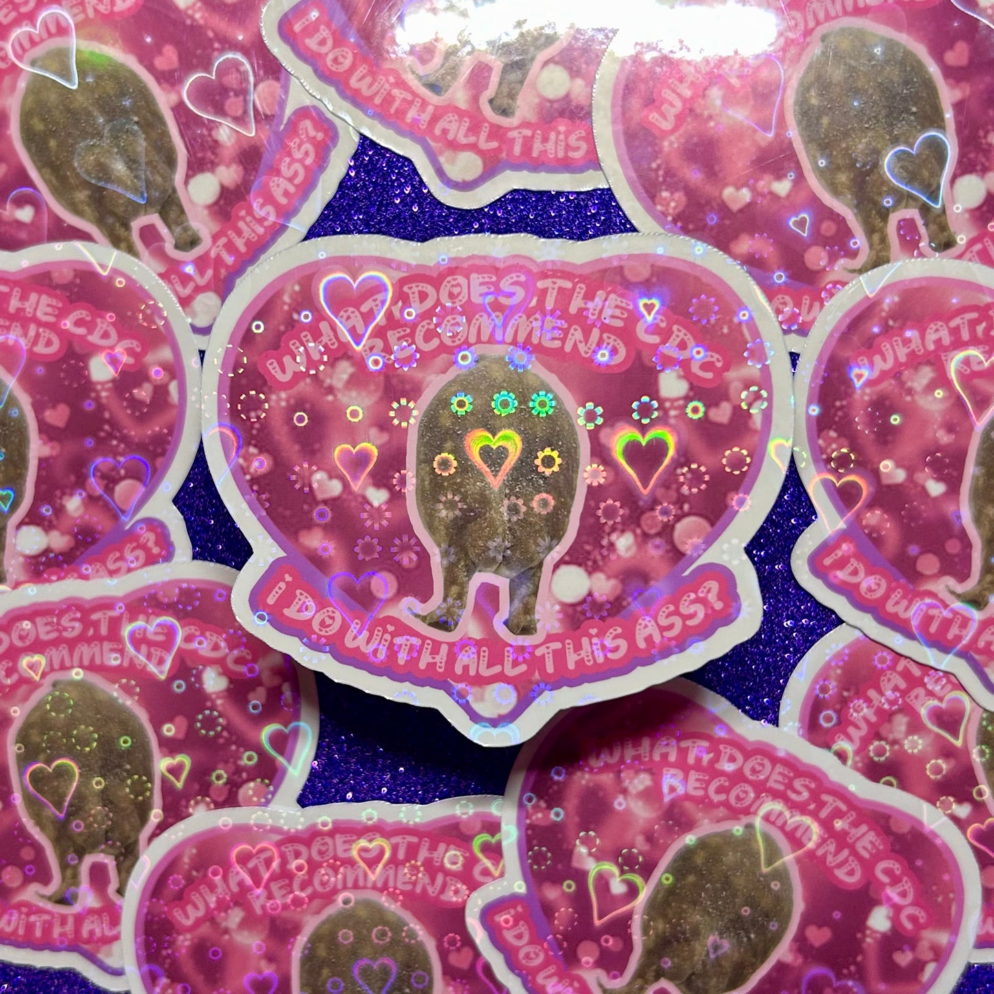Frog butt What Does the CDC Recommend I Do with All this Ass? pink and purple holograhpic heart sticker on a purple background