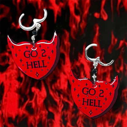 Red and black sparkly devil horns heart "Go 2 Hell" beaded resin dangle earrings on a blurry fiery background