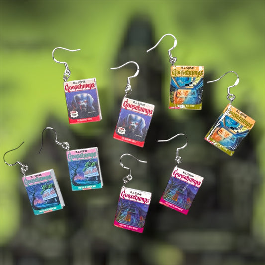 Goosebumps nostalgic horror miniature book dangle earrings on a blurry green background
