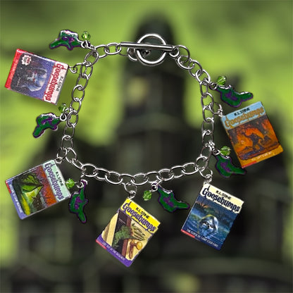 Classic Goosebumps miniature books nostalgic horror charm bracelet on a blurry green background