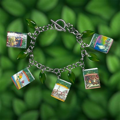 Magic Treehouse miniature book and green leaf charm bracelet on a green leafy background