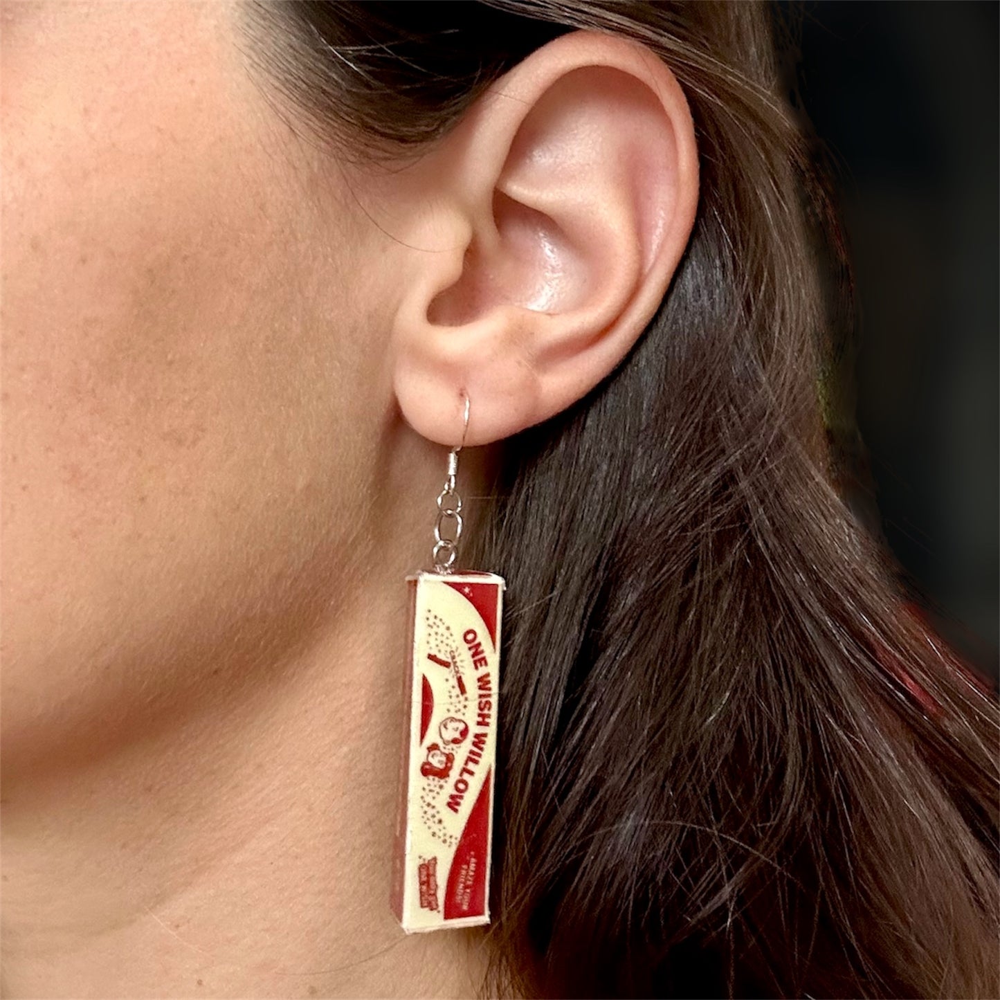 Obsession One Wish Willow horror movie curse dangle earrings being worn on a blurry background Nikki Freeman Bear