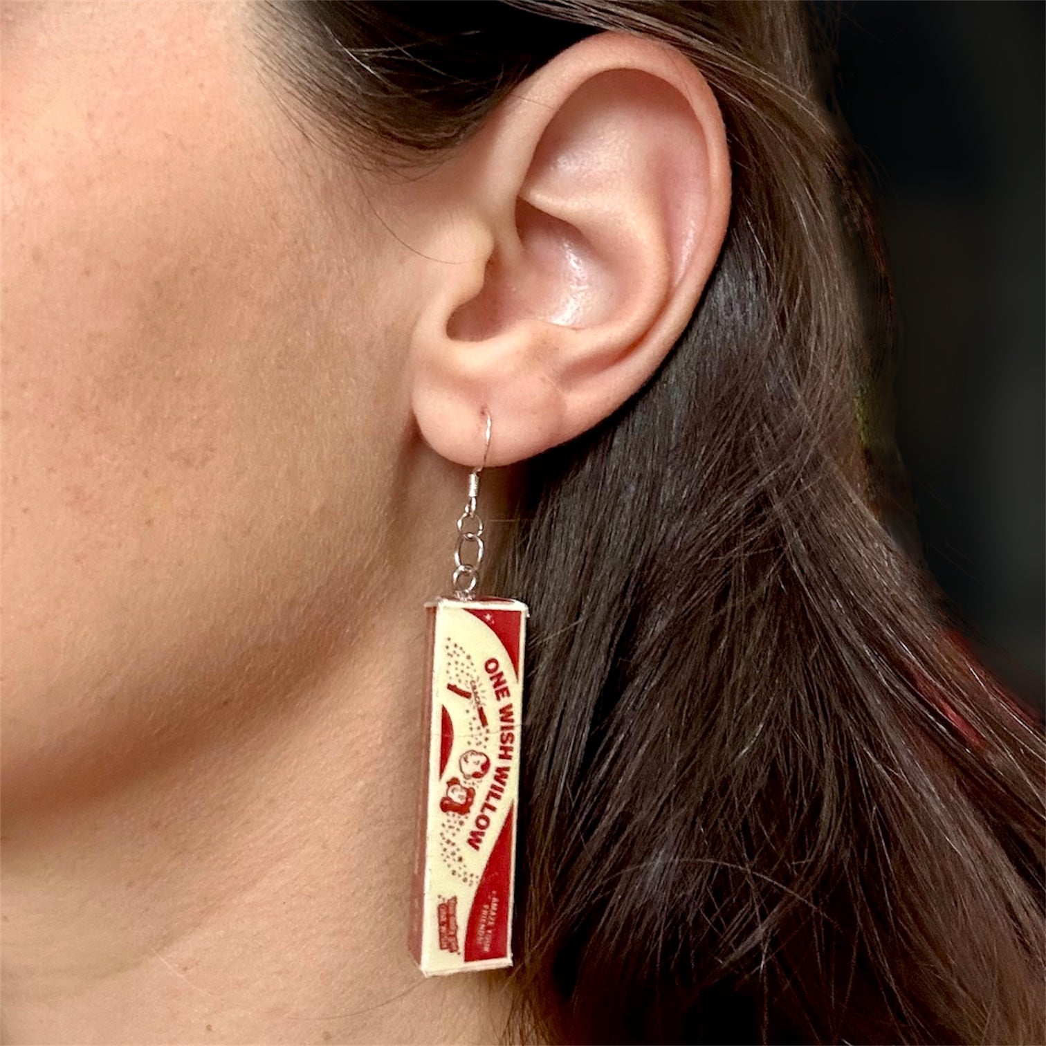 Obsession One Wish Willow horror movie curse dangle earrings being worn on a blurry background Nikki Freeman Bear